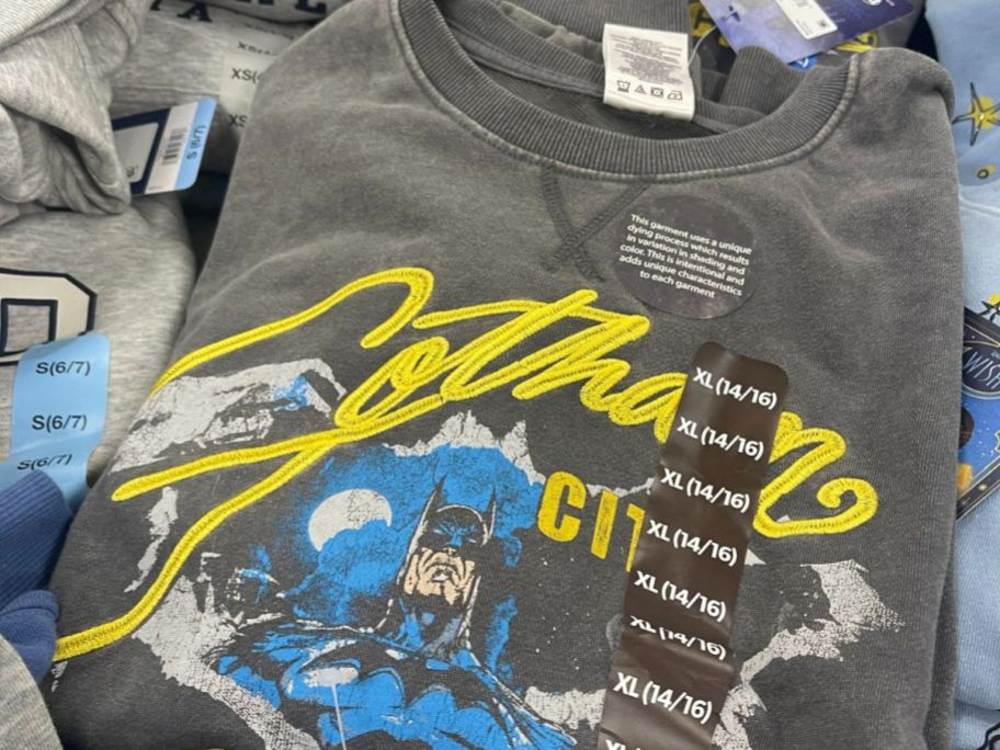 boys's mineral washed Batman pullover shirt on display table