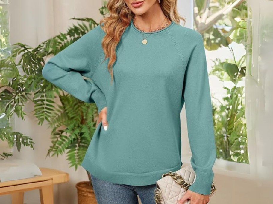 woman wearing a sage teal green color oversized crew neck sweater