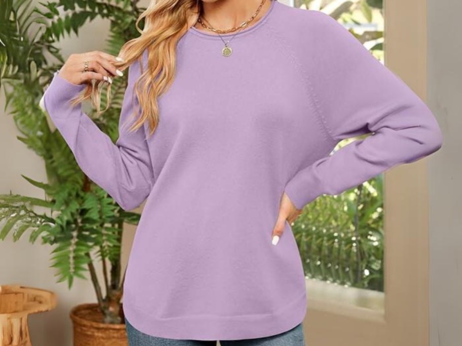 woman wearing a lavender color oversized crew neck sweater