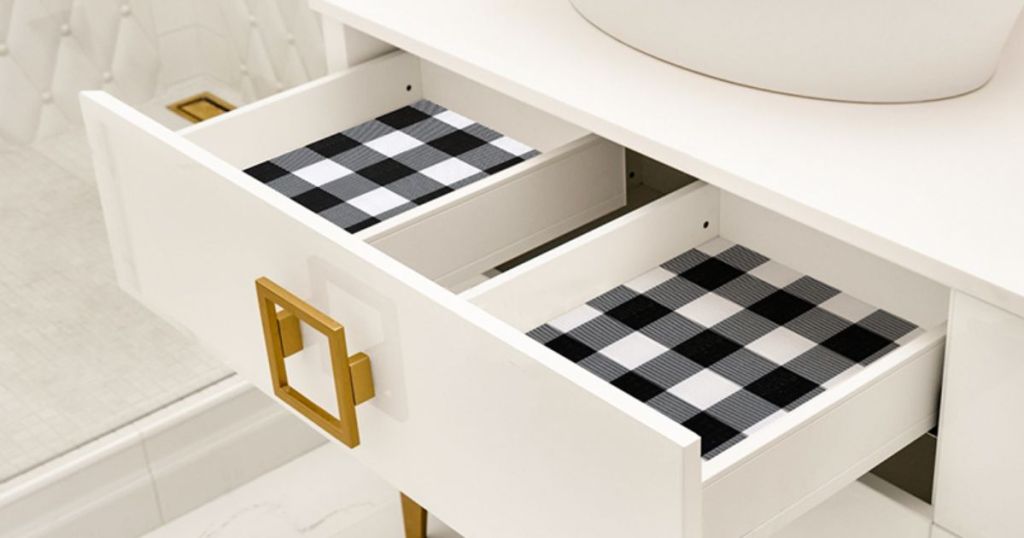 bathroom drawers pulled out showing black and white drawer shelf liner