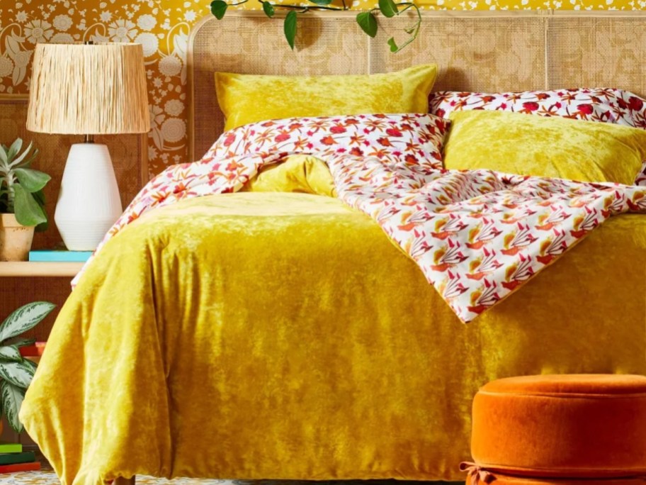 bed with a yellow velvet reversable duvet cover and shams