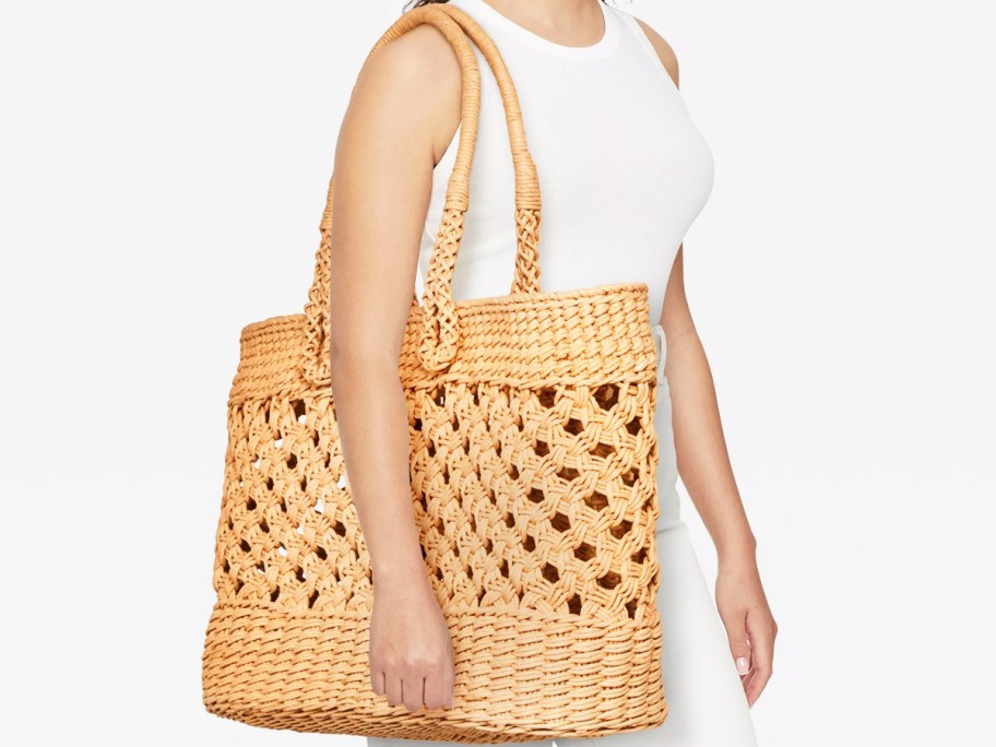 woman with a large straw tote bag