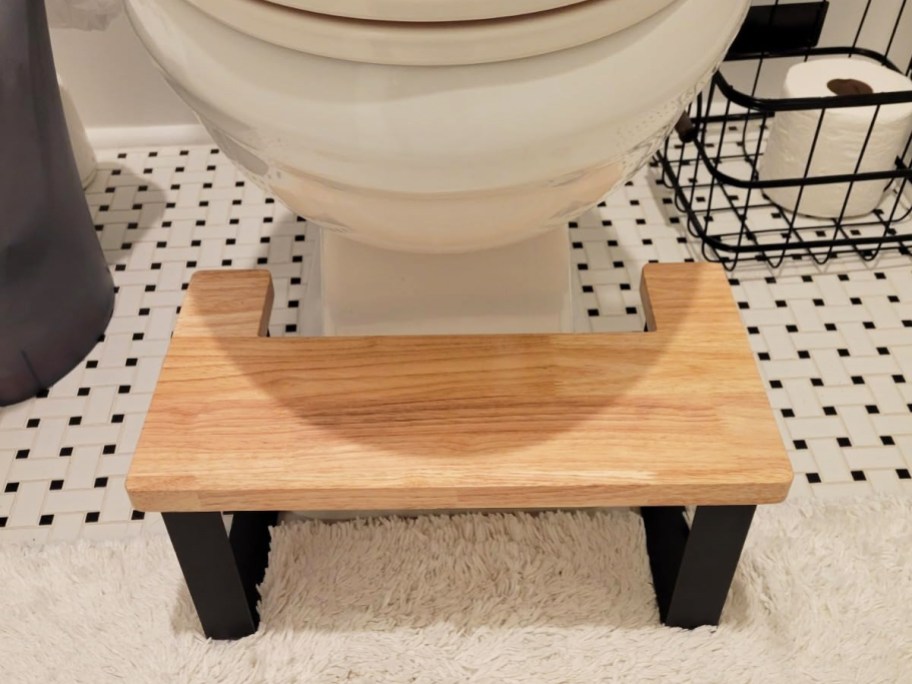 light wood stool under toilet