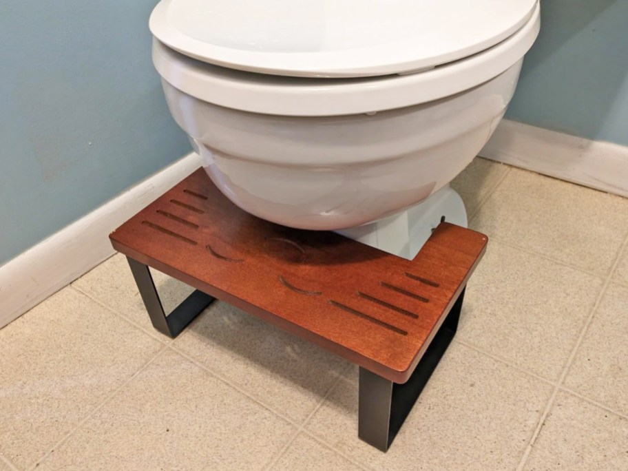 dark wood stool under toilet