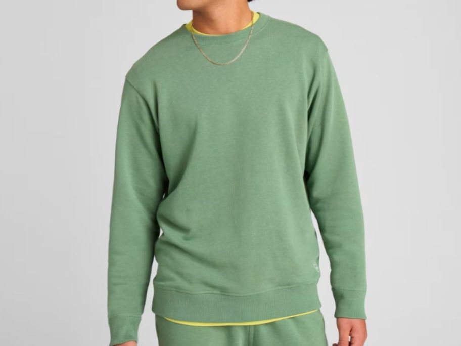 Stock image of a man wearing an Allbirds R&R sweatshirt