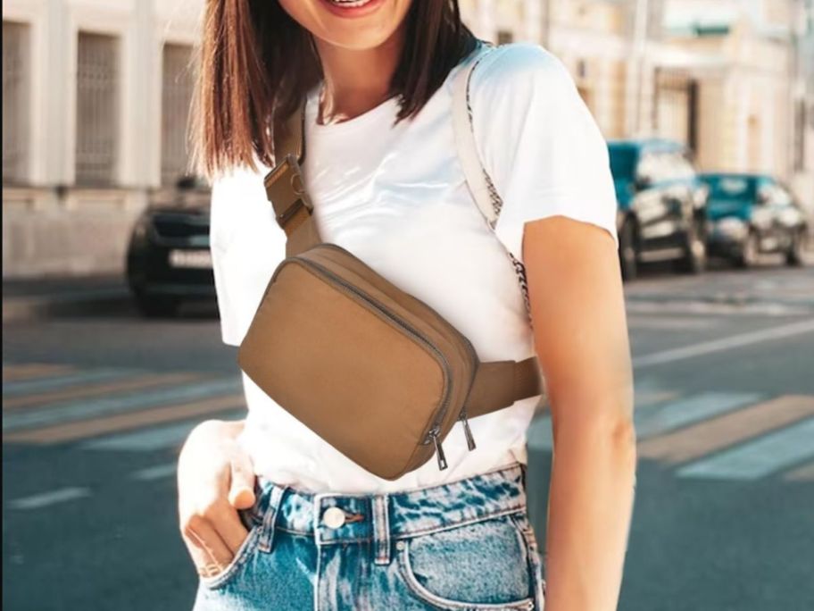 A woman wearing an Amazon Belt Bag in brown