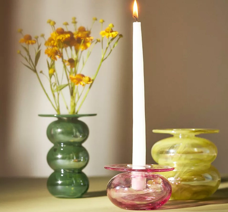 green, pink, and yellow vase/candle holders