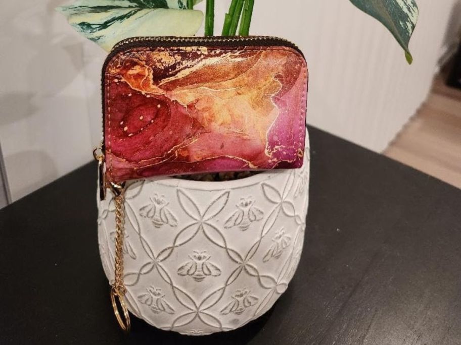 colorful keychain wallet placed on plant stand