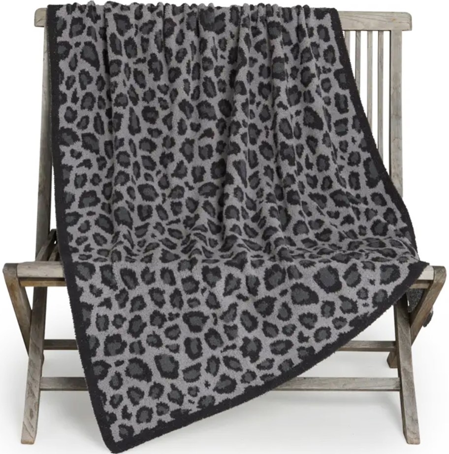 black and grey leopard print throw blanket draped over chair