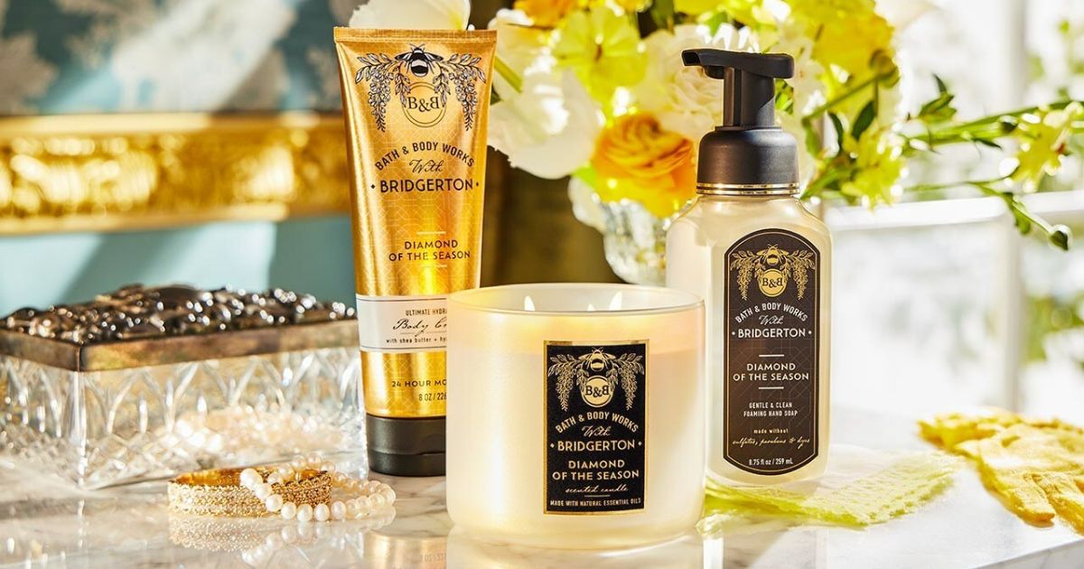 Bath and Body Works Bridgerton Collection with flowers on a desk
