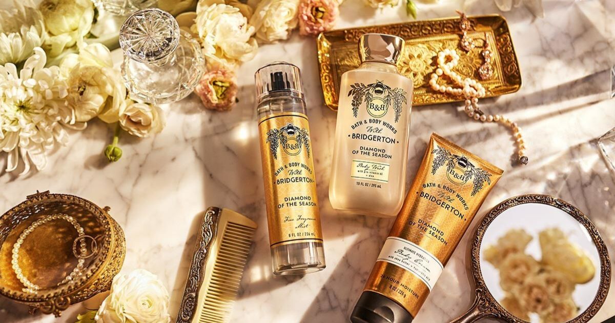 Bath and Body Works Bridgerton Collection with flowers on a desk