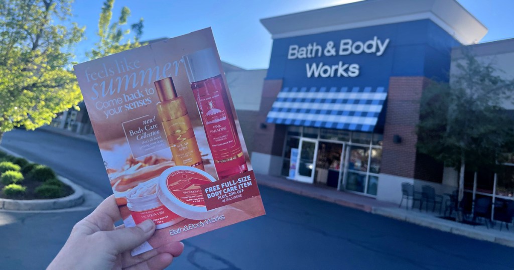 Bath Body Works Mailer held up in front of store