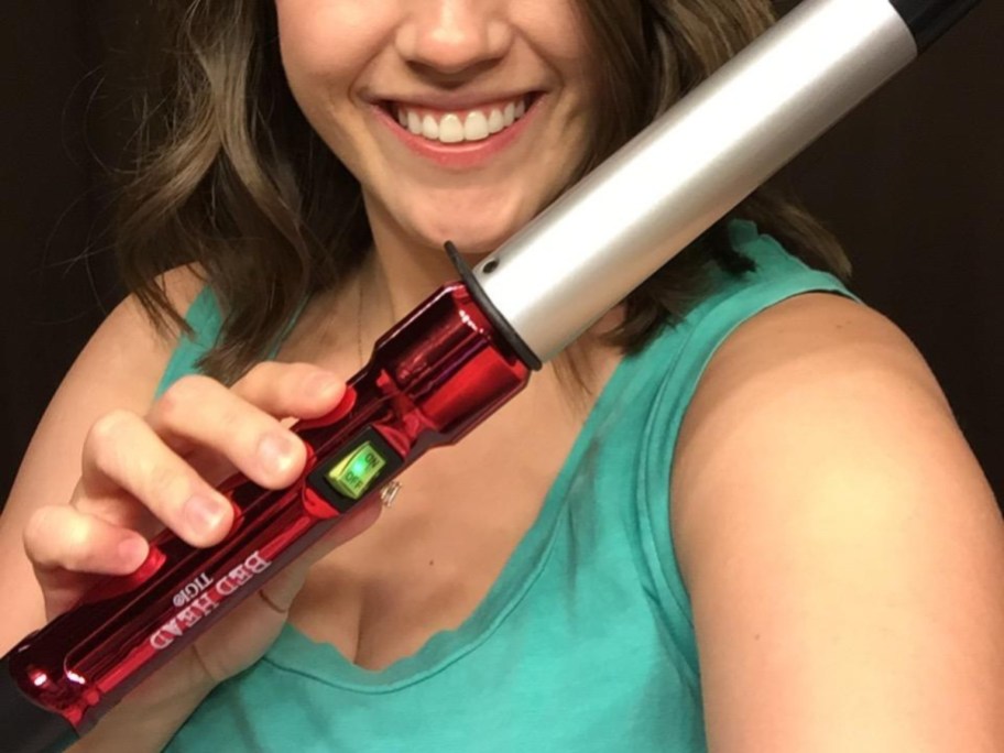 woman holding 1 1/4" bed head curling wand