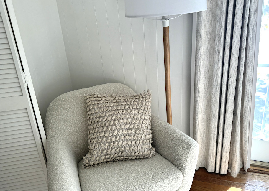 neutral colored nubby pillow on beige accent chair