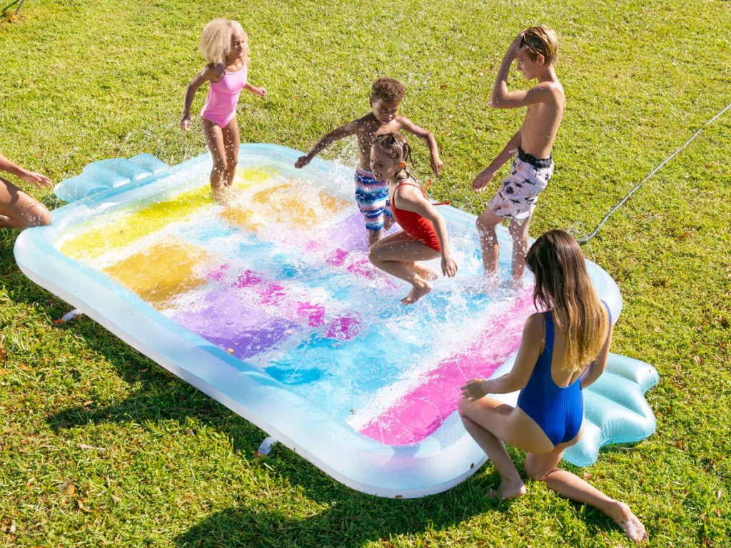kids playing on colorful candy-shaped splash pad