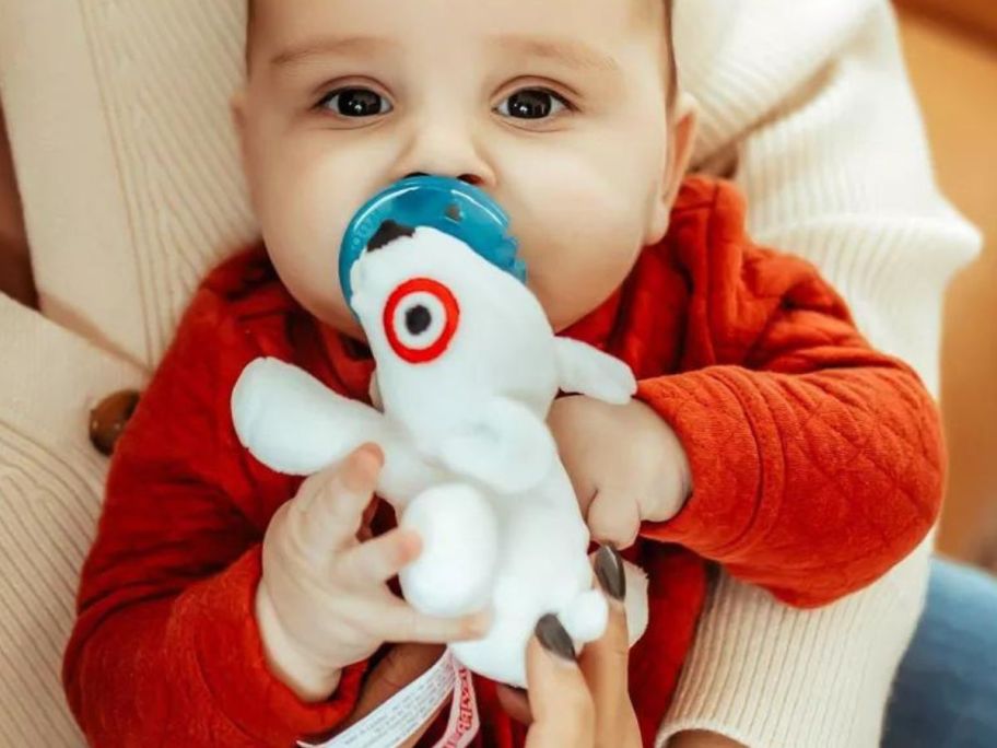 Baby Holding a bullseye Wubbanub from Target
