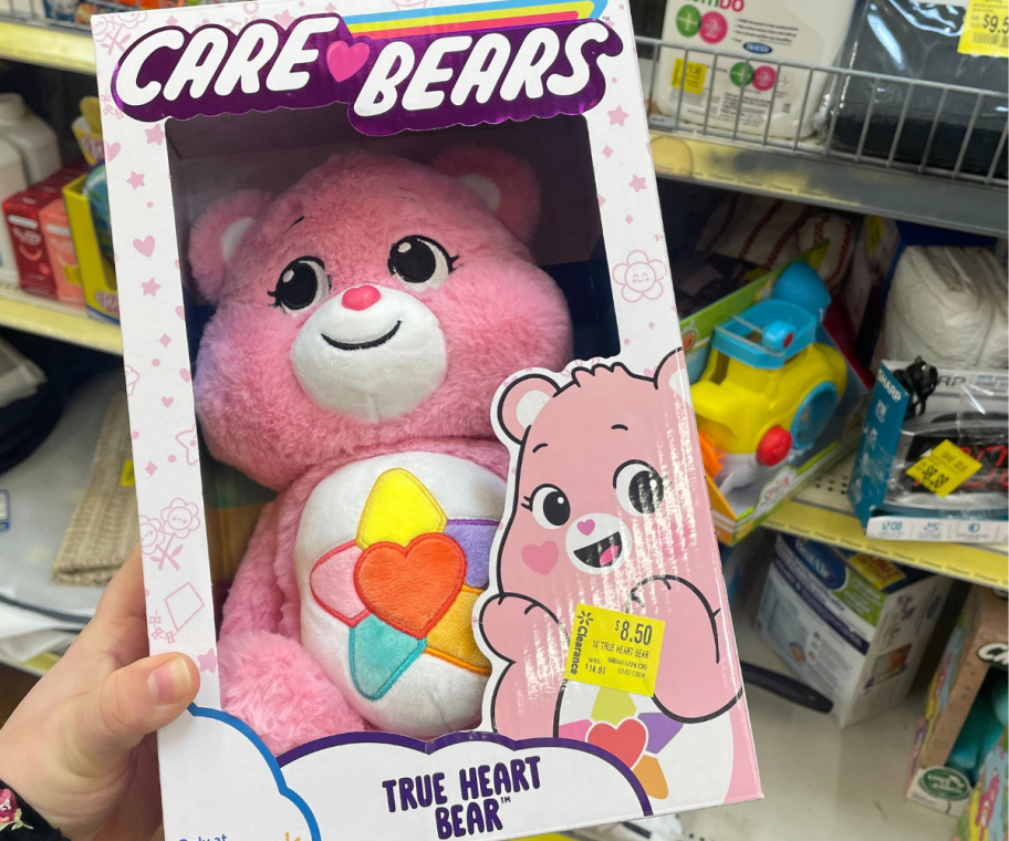 A hand holding Care Bears True Heart Bear