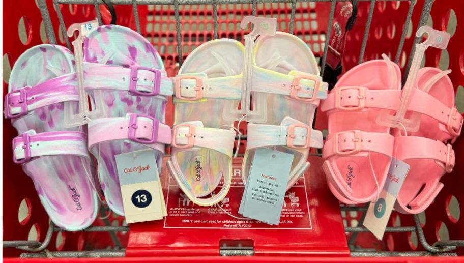3 pair of Cat and Jack kids footbed sandals lined up in a row in a target shopping cart