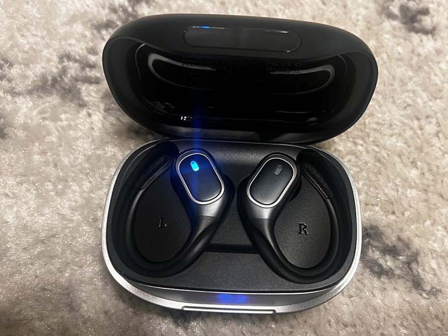 set of black bluetooth headphones in their charging case