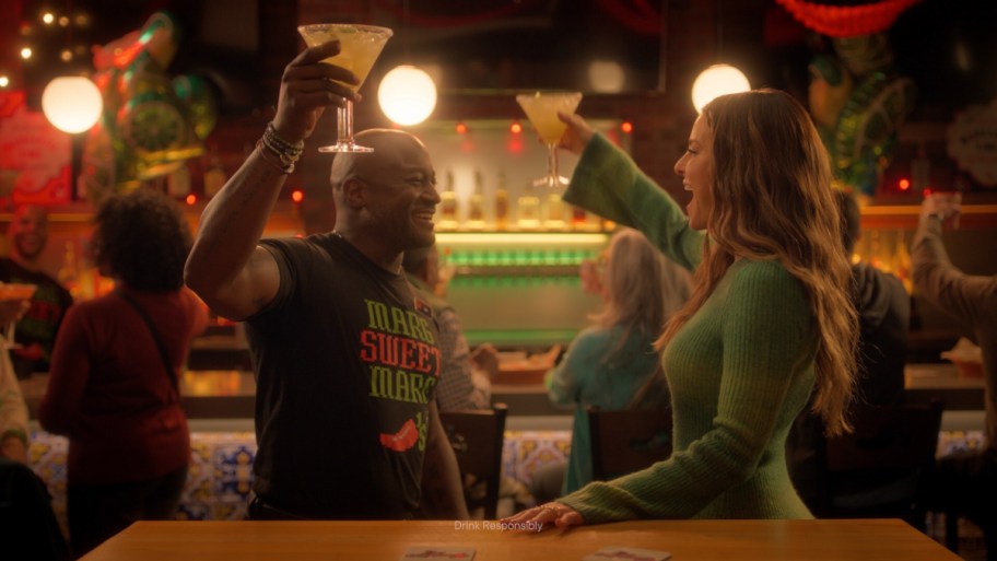 man and woman toasting with Margaritias