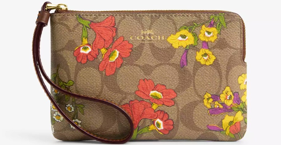 brown coach wristlet with orange and yellow floral print