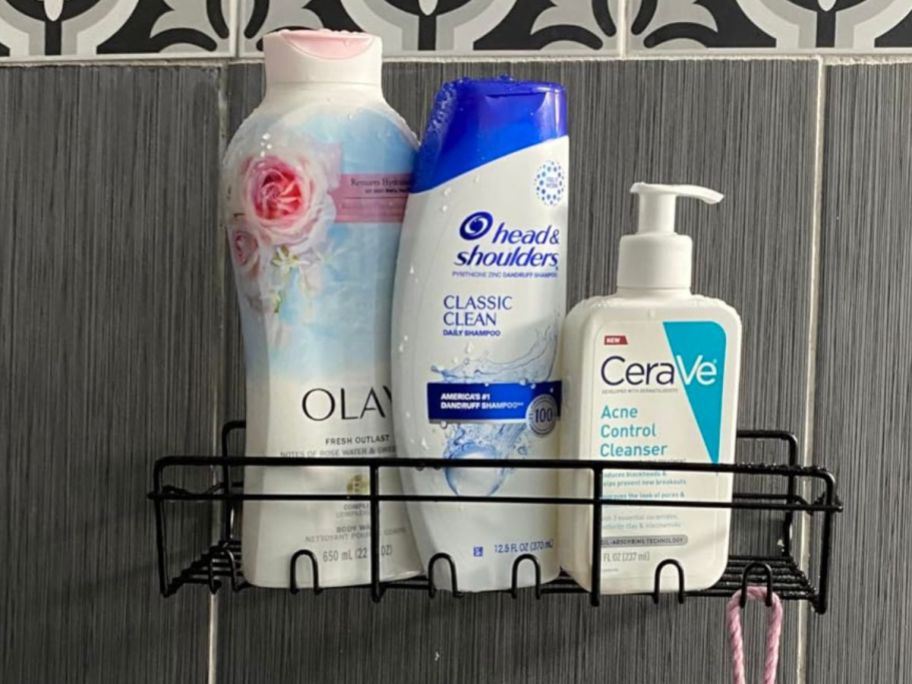 Coraje Adhesive Bathroom Caddy hanging on shower wall with 3 bottles of shampoo and soap