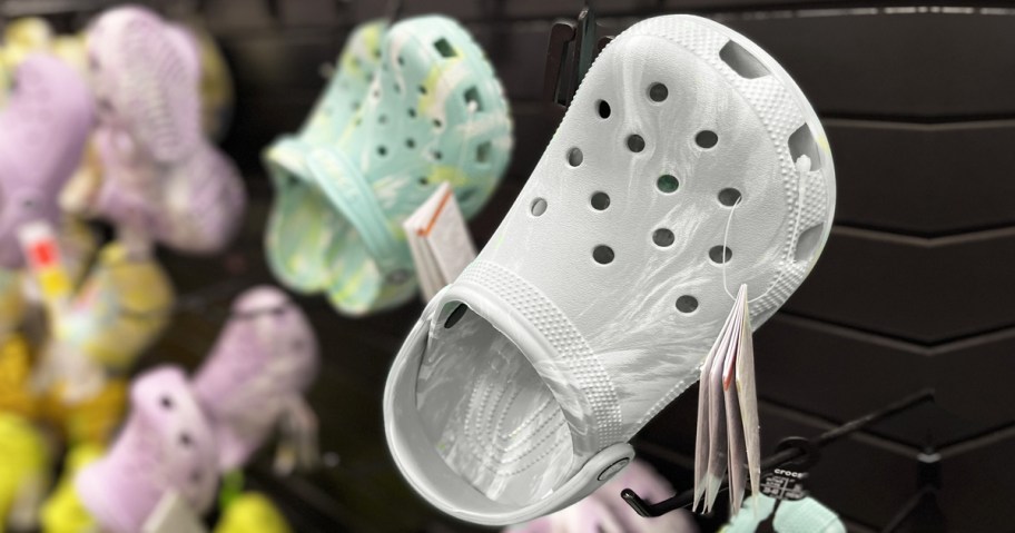 crocs clogs hanging on display in store