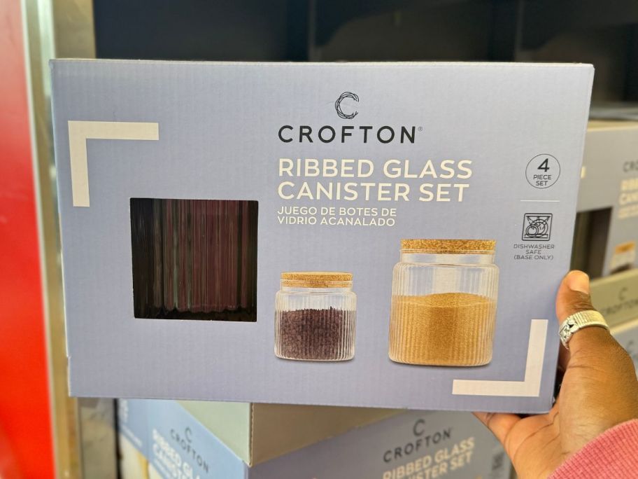 A hand holding Crofton Ribbed Glass Canister Set
