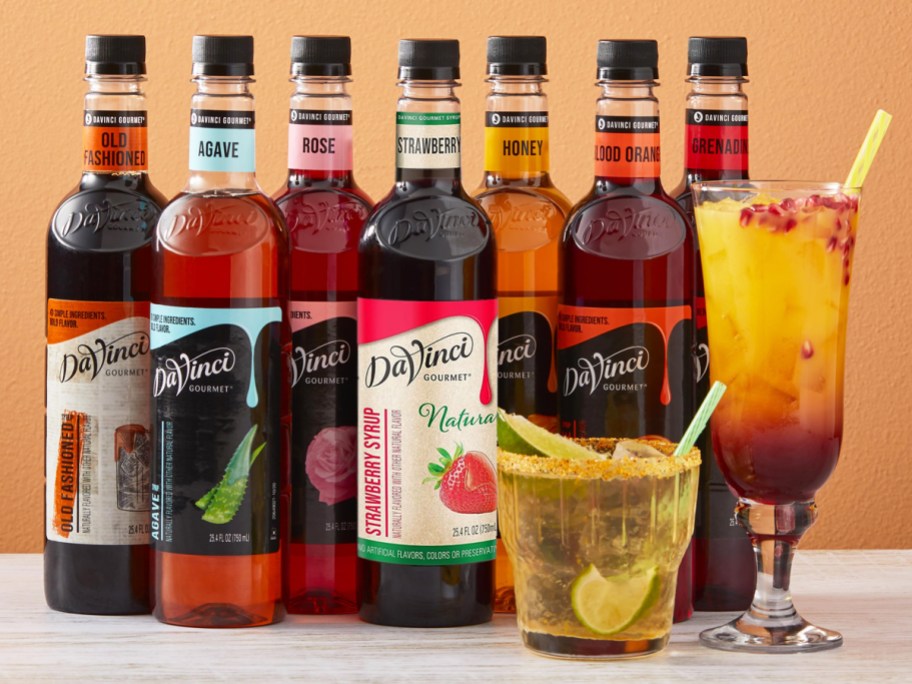 DaVinci Gourmet Syrups in a row behind two drinks