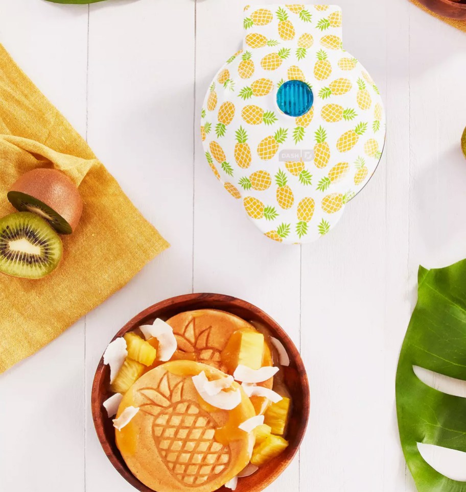 pineapple print mini waffle maker on counter with plate of waffles