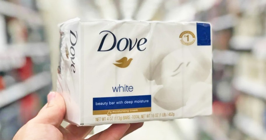 hand holding up a package of dove beauty bars in store