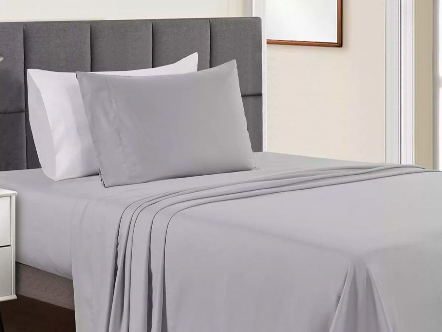 a set of gray sheets on a twin bed