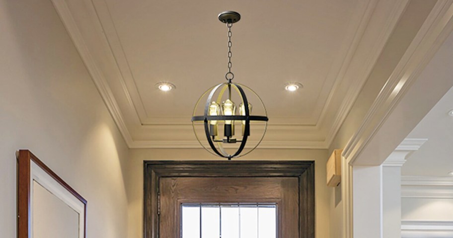 round black pendant light hanging in entryway