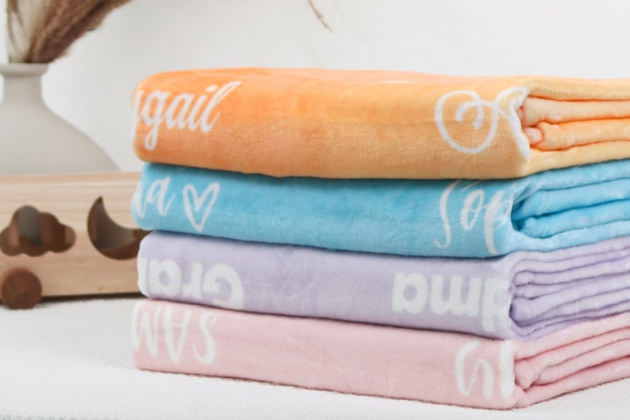 stack of personalized name blankets
