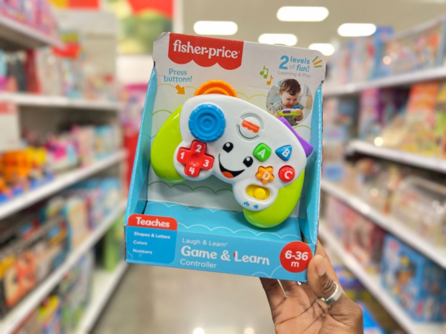 person holding up Fisher-Price Interactive Game & Learn Controller in store