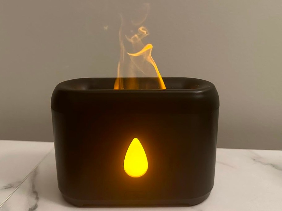 flame essential oil diffuser in black on countertop