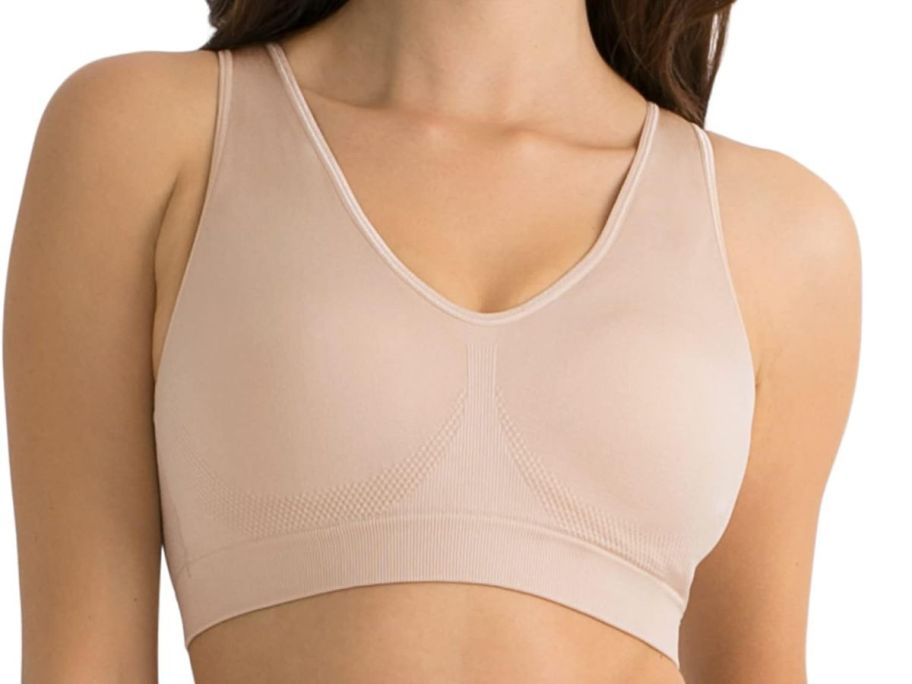 A woman wearing a Fruit of the Loom Seamless Pullover Bra w Built-in Cup in light tan