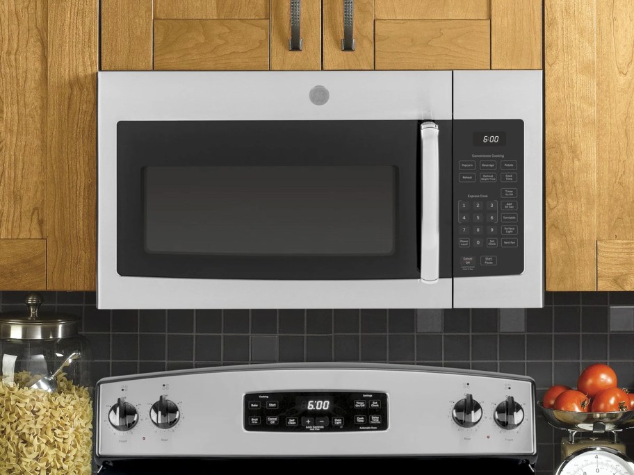 silver and black microwave over stove in kitchen