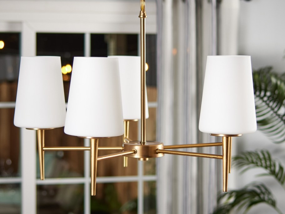 modern brass chandelier with white lamp shades