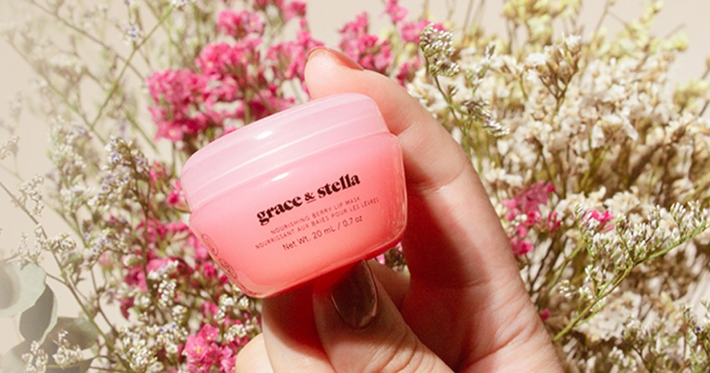 hand holding a pink jar of Grace & Stella lip mask