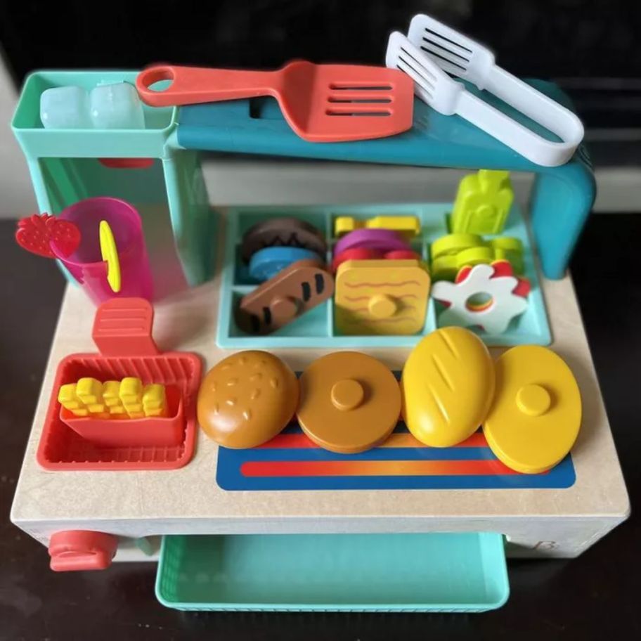 kid's toy build a burger food set shown with all the accessories