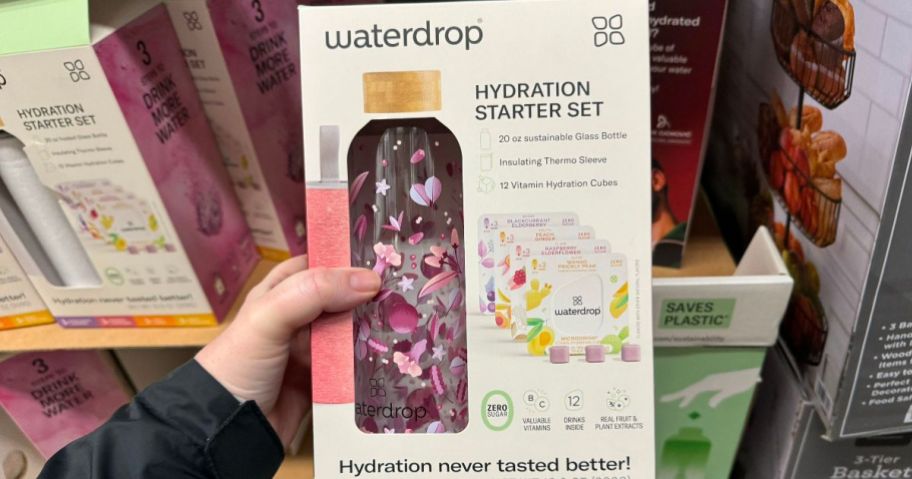 hand holding a box with Waterdrop Hydration Starter Pack bottle and set