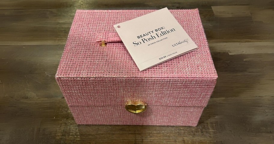 pink tweed looking makeup case box with a gold heart lock, tag on it says Beauty Box: So Posh Edition - Ulta Beauty