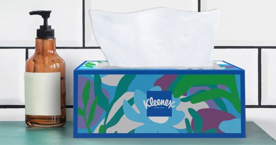 brightly colored box of Kleenex tissues on counter with soap bottle next to it