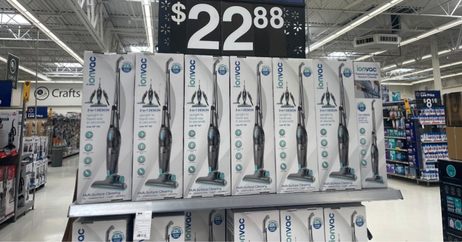 Walmart endcap with IonVac 3-in-1 Corded Stick Vacuums in boxes and sign that says $22.88