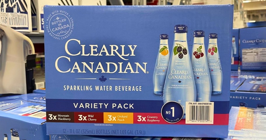 a blue box of Clearly Canadian Sparkling Water variety flavors on a stack of more in Sam's club