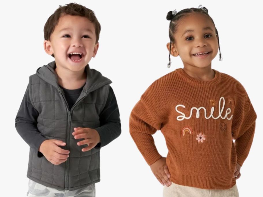 little boy wearing a black hooded vest and shirt and little girl wearing a brown sweater that says "smile"