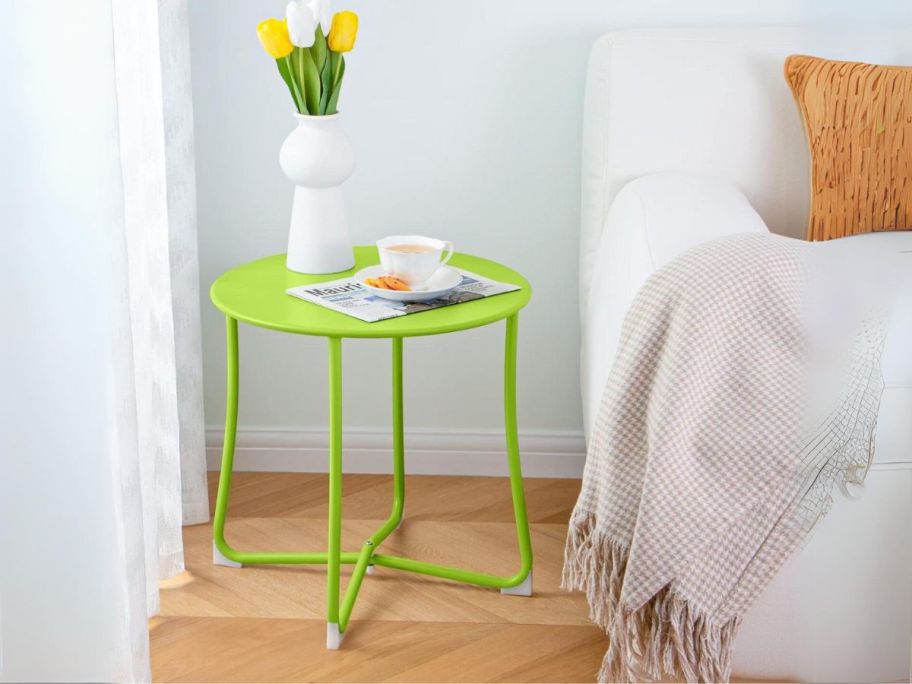 Metal Accent Table in Lime Green used as a side table by a bed
