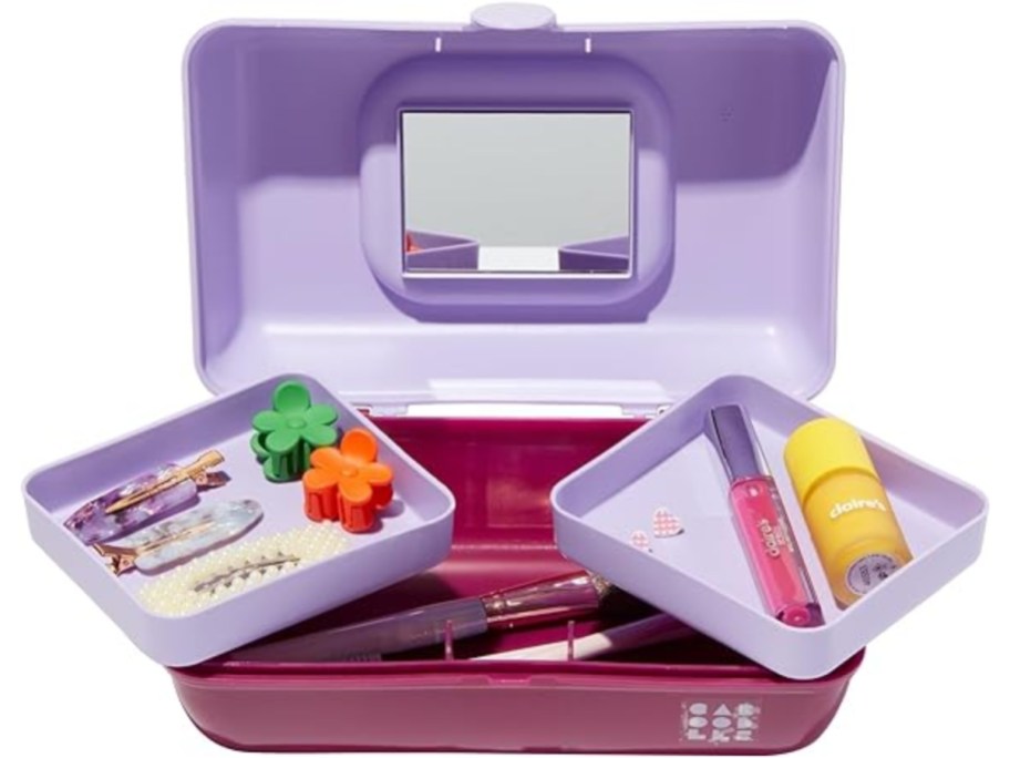 light purple and dark pink caboodles makeup case open showing inside pieces with makeup and hair accessories