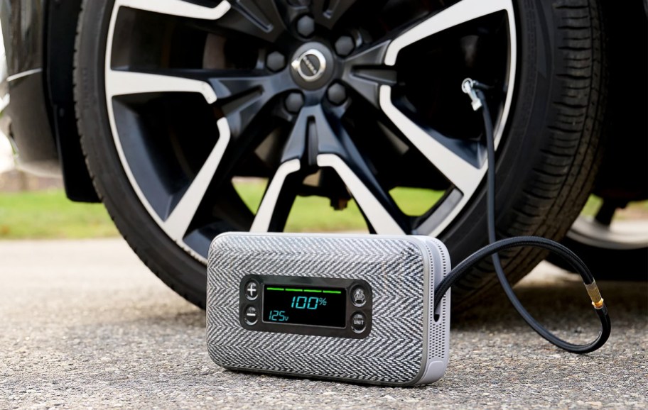using a portable tire inflator on a car tire